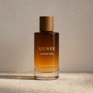 Kilwee Cloud Veil perfume bottle with a wooden cap, amber gradient glass, sitting on a textured gray surface.